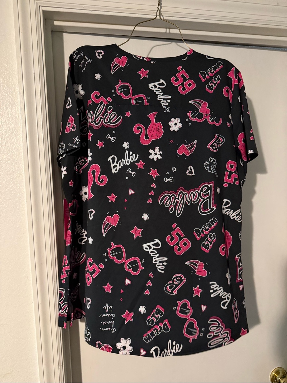 Barbie Black and Pink Logo Graphic Top (Women's Scrubs) top with 2 pockets.